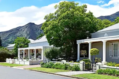 a house in a suburb with mountains in the background at The Coach House in Franschhoek