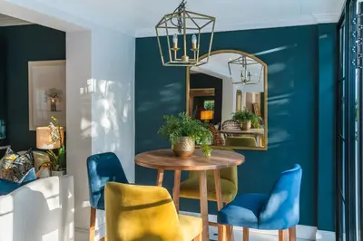 a dining room with blue walls and a table and chairs at Last Word Franschhoek in Franschhoek