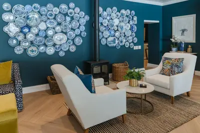a living room with blue walls with plates on the wall at Last Word Franschhoek in Franschhoek