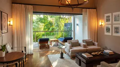 a living room with a couch and a table at Delaire Graff Lodges and Spa in Stellenbosch
