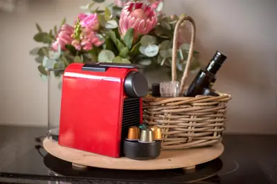 a basket with a red toaster and a bottle of wine at Avemore Vredehof No 3 full back up power in Stellenbosch