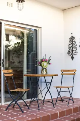 a table and two chairs on a patio at Avemore Vredehof No 3 full back up power in Stellenbosch