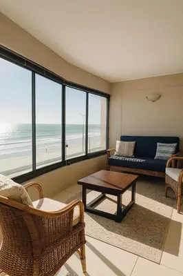 a living room with a couch and a table at Luxurious Beach Front in Strand