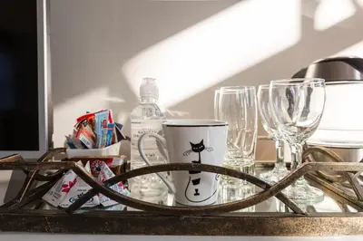 a tray with glasses and a mug on a table at Atlantic Beach Villa in Cape Town