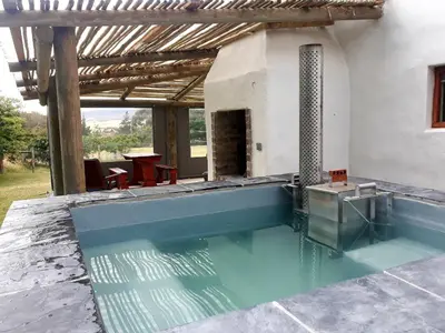 a swimming pool in the middle of a house at The Cottage at Nuwejaarsrivier Farm in Kleinmond