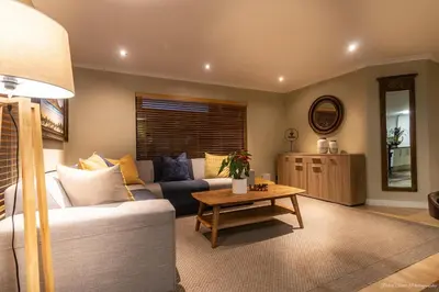 a living room with a couch and a table at Atlantic Bay Lodge in Cape Town