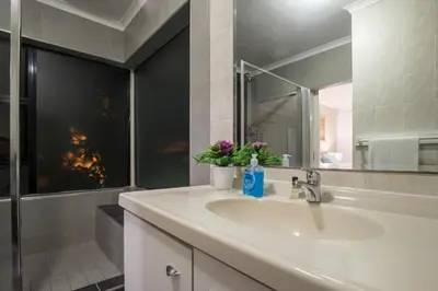 a bathroom with a sink and a mirror at Atlantic Bay Lodge in Cape Town