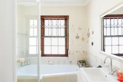 a bathroom with a tub and a sink at Nansen Place in Cape Town