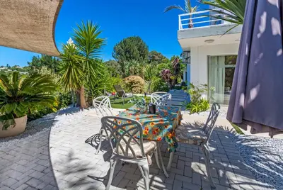 a table and chairs sitting on a patio at Morgen Guesthouse Somerset West in Somerset West