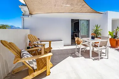 a patio with chairs and a table on a patio at Morgen Guesthouse Somerset West in Somerset West
