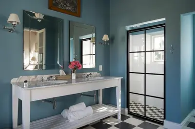a bathroom with two sinks and a large mirror at La Cotte Orchard Cottages in Franschhoek