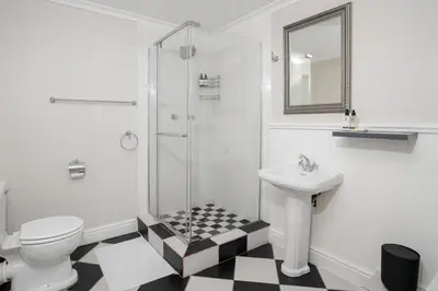 a bathroom with a toilet sink and a shower at Dark Chocolate Guest House in Durbanville