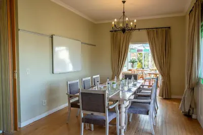 a dining room with a long table and chairs at Zevenwacht Country Inn in Kuilsrivier