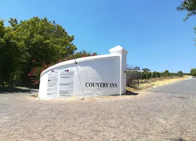 a sign for a country inn on the side of a road at Zevenwacht Country Inn in Kuilsrivier