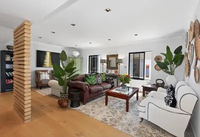 a living room with a couch and a table at The Whale's Tale Guesthouse in Hermanus