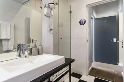 a bathroom with a sink and a shower at Life & Leisure Boutique Guesthouse in Stellenbosch