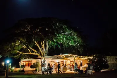 a group of people standing under a tree at night at Damas Guest Farm in Worcester