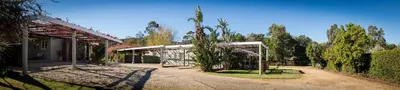 a building with a pavilion in a yard with trees at Damas Guest Farm in Worcester