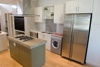 a kitchen with a stainless steel refrigerator and a dishwasher at 14 On Louw in Stellenbosch