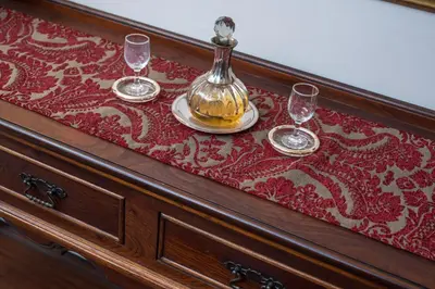 a table with two wine glasses and a bottle on it at Blaauwheim Guest House in Somerset West
