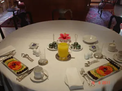 a white table with food and a glass of orange juice at Blaauwheim Guest House in Somerset West