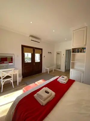 a bedroom with a bed with towels on it at @Leisure Guest Suite in Stellenbosch
