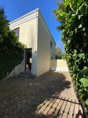 a white building with a brick driveway at @Leisure Guest Suite in Stellenbosch