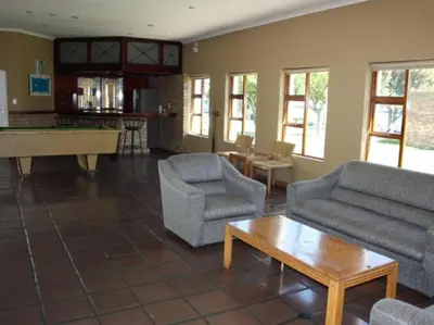 a living room with couches and a pool table at Amies Self-Catering Apartments in Panorama
