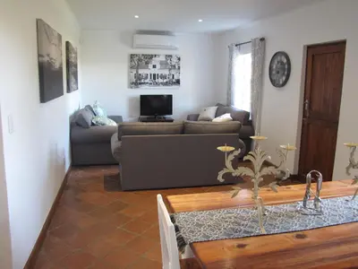 a living room with a couch and a table at Induku in Stellenbosch