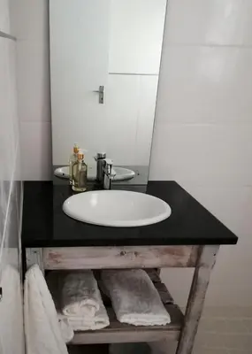 a bathroom with a sink and a mirror at Annika Self-catering and B&B in Stellenbosch