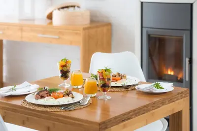 a table with plates of food and glasses of orange juice at Bamboo Guest House in Hermanus
