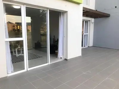 an empty patio with sliding glass doors on a house at 131 Yellowwood Ashton Park in Cape Town