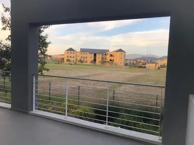 a view of a field from a window at 131 Yellowwood Ashton Park in Cape Town