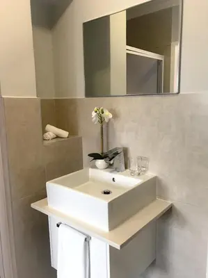 a bathroom with a white sink and a mirror at 131 Yellowwood Ashton Park in Cape Town