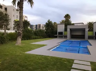 a swimming pool in the yard of a building at 131 Yellowwood Ashton Park in Cape Town