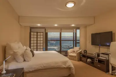 a bedroom with a large bed and a television at Ocean View 201A in Strand