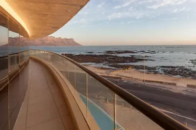 a view of the ocean from the balcony of a building at Ocean View 201A in Strand