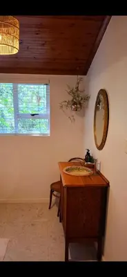 a bathroom with a wooden sink and a mirror at The Wild Fig in Durbanville