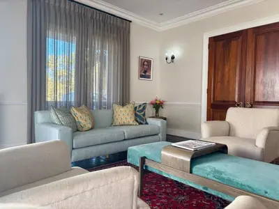 a living room with a couch and chairs and a table at Lemoenkloof Boutique Hotel in Paarl