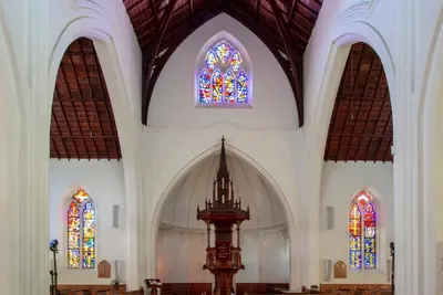 an empty church with two stained glass windows at De Hoek Manor in Stellenbosch