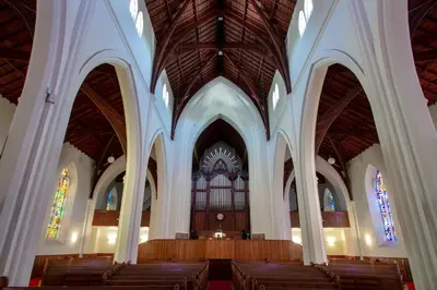 an empty church with pews and stained glass windows at De Hoek Manor in Stellenbosch