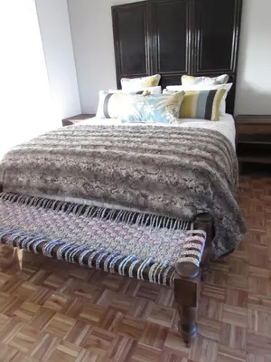 a bed with a blanket and pillows in a bedroom at Live Like a Local: Studio 29 @ 25 Market street in Stellenbosch