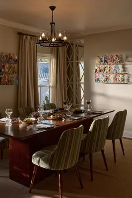 a dining room with a table with chairs and a dining room at Le Quartier Francais in Franschhoek