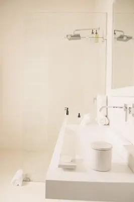 a white bathroom with a sink and a mirror at Homestead Villas in Bellville
