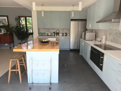 a kitchen with blue cabinets and a counter top at Modern spacious home in heart of Cape Winelands in Somerset West