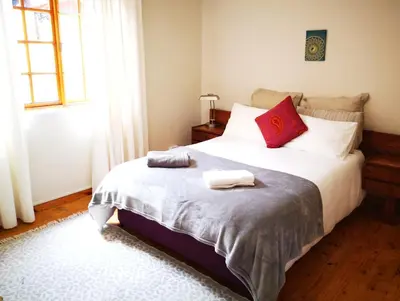 a bedroom with a bed with two towels on it at Getaway on Peck Way in Edgemead