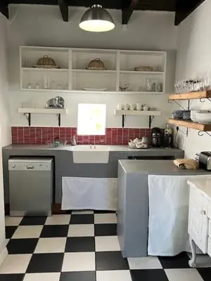 a kitchen with a black and white checkered floor at The Prime Spot Self Catering in Worcester