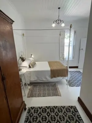 a bedroom with a bed and a table in it at The Prime Spot Self Catering in Worcester