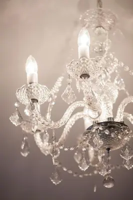a close up of a chandelier with two candles at Heuwelsig Farm Cottages in Franschhoek