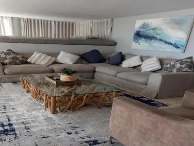 a living room with a couch and a coffee table at Cape Beach Penthouse in Cape Town